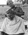 'Tony Troiano gives Derek Hawkins a trim',  3rd County of London Yeomanry (Sharpshooters)North West Europe, 1944