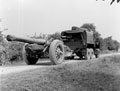 A truck pulling a 7.2 inch howitzer along a country road, 1944 (c)