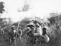 Gurkhas outside a burning village, Abor Expedition 1911 (c)
