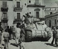 A Sherman tank passing through the town of Francofonte, 1943