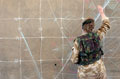 A 2nd Lieutenant from the Irish Guards prepares a large scale map, Iraq, March 2003