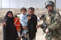 An Iraqi family seek the help of a soldier serving with 1st Battalion Irish Guards, Basra, Iraq, March 2003