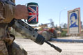 A soldier serving with 1st Battalion Irish Guards resting with a mug of tea on the outskirts of Basra, Iraq, March 2003