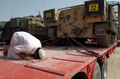 A civilian driver from Pakistan performs his prayers on a Heavy Equipment Transport, Operation BRACKEN, October, 2004