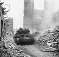 .British tanks advancing through rubble of Udem, 28 February 1945