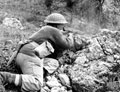 Ghurkha soldier firing a Thompson sub machine gun, 1944