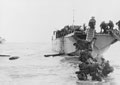 Commandos wade ashore from landing craft at Juno beach, June 1944