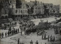 A British Army band playing to troops in a square at Arras, 1918
