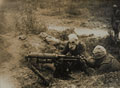 A Vickers machine gun team in gas masks, 1916 (c)