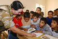 A British Army officer helps out in a Basra school, 2003