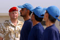 A Royal Military Policeman instructs Iraqi police recruits, 2003
