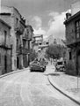 Carrier driving through a town, Sicily, 1943