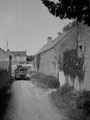 'Sgt. Freddy White's tank coming through the village of Ver-Sur-Mer after leaving the de-waterproofing area and moving to the regimental concentration area.', Normandy, 1944
