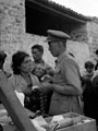'Bill Sillar treating a refugee', Sicily, 1943
