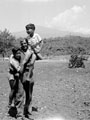 Bill Harrison of 3rd/4th County of London Yeomanry (Sharpshooters) poses with two Sicilian boys, 1943