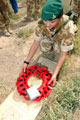 A young lance corporal of the Intelligence Corps lays a wreath at Basra War Cemetery, Iraq, 2003