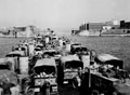 Landing Ship Tank heavily loaded with trucks and a recovery vehicle approaching Taranto, Italy, 1943