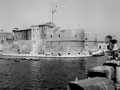 'The fort at the entrance to the inner basin'. Allied landing ships approach the Ponte Girevole, Taranto, Italy, 1943