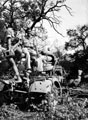 Two members of 3rd County of London Yeomanry sit on a knocked out German 88mm gun in Italy, 1943