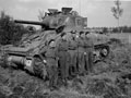 Four members of 'B' Squadron, 3rd/4th County of London Yeomanry (Sharpshooters) next to their Sherman tank, 1944 (c)