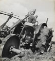 A member of the Women's Land Army driving a tractor, 1944 (c)