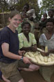 A student from Tayforth University Officer Training Corps with locals in Wisikoti, Malawi, 2002
