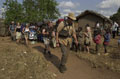 Army Cadets from Tayforth University Officer Training Corps marching through the village of Wisikoti, Malawi, 2002