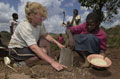 A student from Tayforth University Officer Training Corp helping a local to prepare his field in Wisikoti, in central Malawi, 2002