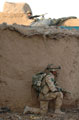 A soldier from 3rd Battalion The Parachute Regiment taking cover by a wall in Now Zad, 2006