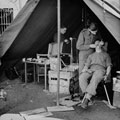 Captain Rushby practising dentistry on a patient in the front line, February 1943