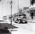 A Quad tractor of 64th Anti-Tank Regiment tows an anti-tank gun  through the town of Adrano, Sicily, August 1943