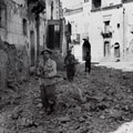 The 6th Battalion, West Kent Regiment, patrolling a damaged area of Adrano, Sicily, 1943