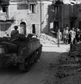 A Military Policeman directing vehicles in the town of Bronte, Sicily, 1943