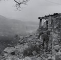 New Zealand infantry entering Cassino, taking cover in ruined houses, Italy, March 1944