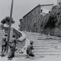 Infantry moving through the streets of Castiglione clearing any remaining German enclaves, June 1944