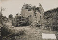 'A Churchill tank awaits possible enemy counter-attack in a ruined Normandy village', July 1944