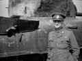 'Smug', Major Oliver Woods MC, 3rd/4th County of London Yeomanry (Sharpshooters), poses next to a shell hole in his Sherman tank, Uedem, Germany, 1945