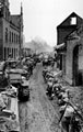 Infantry and tanks moving through Brunen, 1945