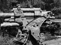 Captain Phillip Millington MC, sitting on a knocked out 88 mm gun north of Kirchlinteln, Germany, 1945