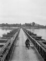 A motorcycle despatch rider crosses a pontoon bridge over the River Elbe, May 1945