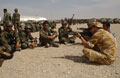 A British soldier from the Operational Mentor and Liaison Team talks to Afghan National Army soldiers about marksmanship, 2006