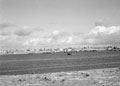 'Tobruk from across the Bay. The gunboat 'Ladybird' lies awash.', Libya, 1942