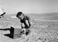 A soldier from 3rd County of London Yeomanry (Sharpshooters) using a stove in North Africa, 1942 (c)