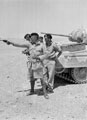 A member of 3rd County of London Yeomanry fires his .38 inch revolver, North Africa, 1942