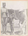 Captain Plummer and a child holding a large rat killed by the photographer's dog, 1902 (c)