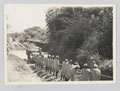 Men of the 4th (Uganda) Battalion, King's African Rifles pulling a vehicle out of a ford, 1939