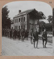 'London Territorials passing a ruined house on the shell-swept La Bassee Road, 1916