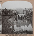 'The Flanders mud hampers our artillery moving a held gun from flooded and shell-pitted position', 1915 (c)