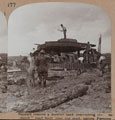 'Sappers remove a derelict tank obstructing the "corduroy" road built over the mud, before Peronne', 1918 (c)