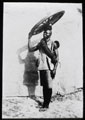 A member of the Northern Nigeria Regiment balances an artillery wheel on his head, 1907 (c)